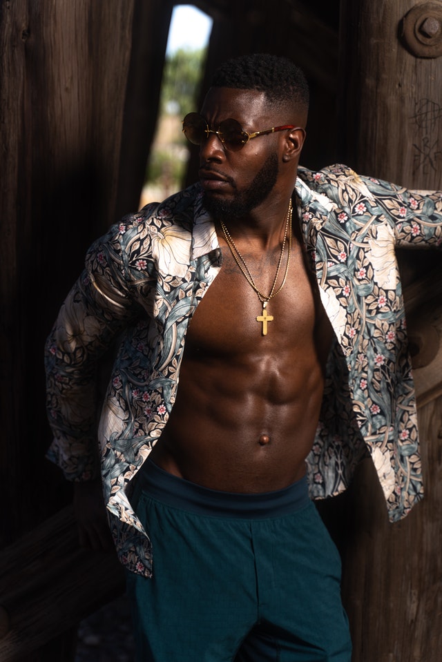 shirtless black man with heavy beard stubble