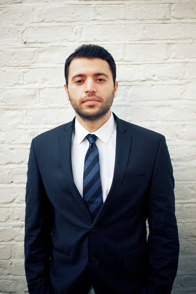 man in suit with heavy stubble beard