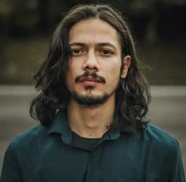 man with van dyke beard and long hair