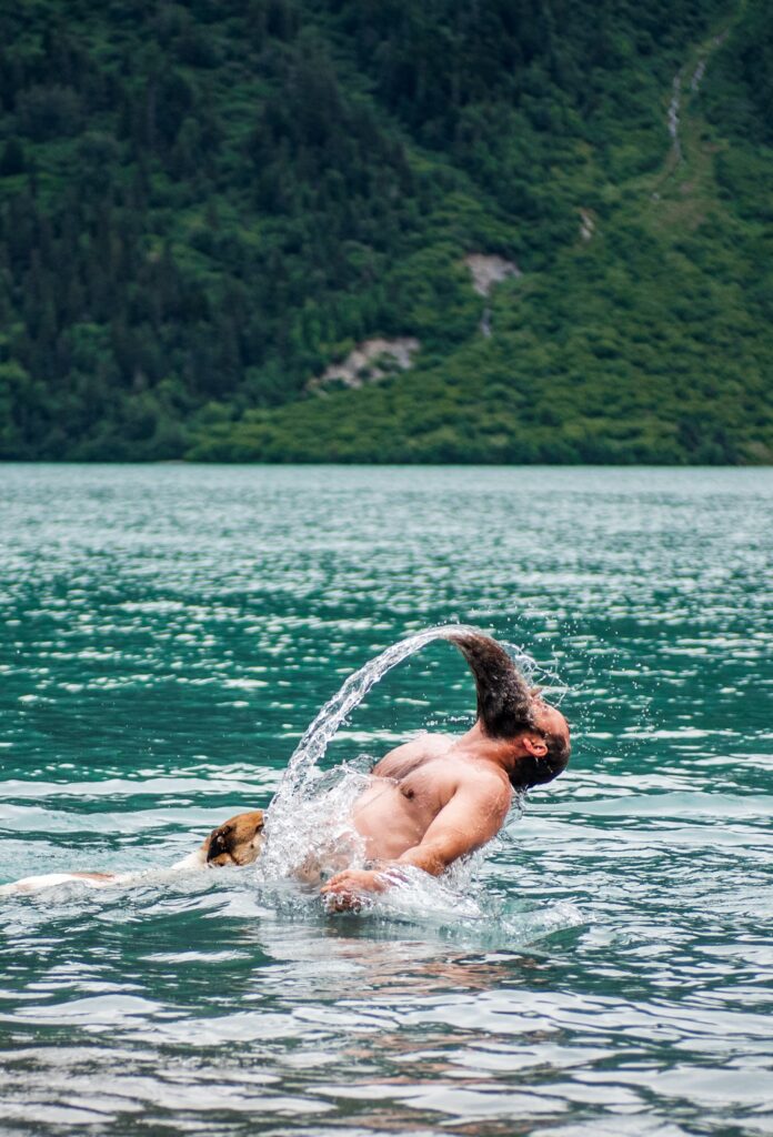 man cleaning beard in water