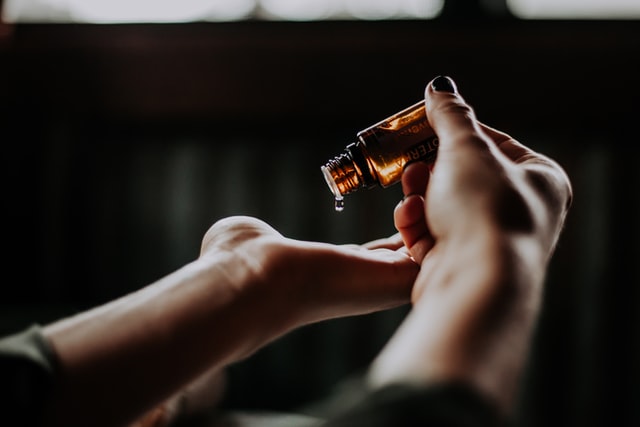 man applying argan oil to beard