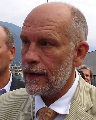 John Malkovich with bald head and beard