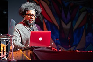 Questlove with beard sitting with Macbook