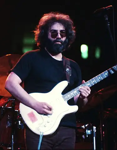 Jerry Garcia with a beard playing guitar