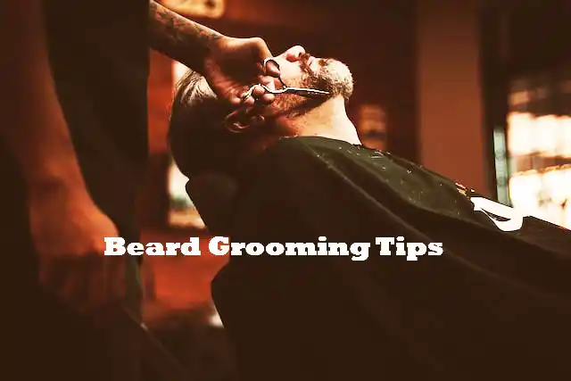 man getting his beard groomed at barber