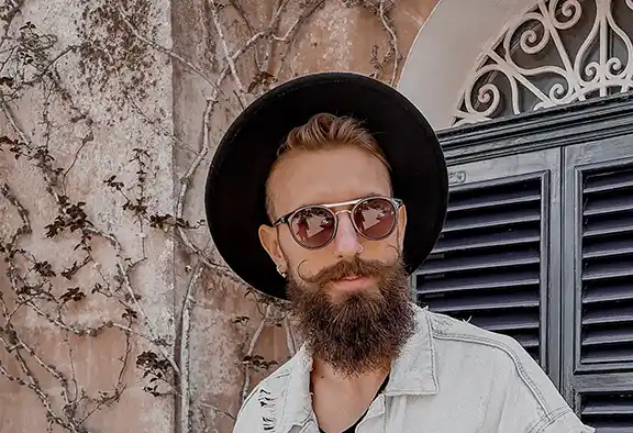 man with handlebar mustache wearing hat and sunglasses