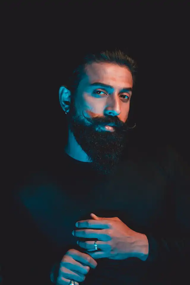 man posing with a long ducktail beard